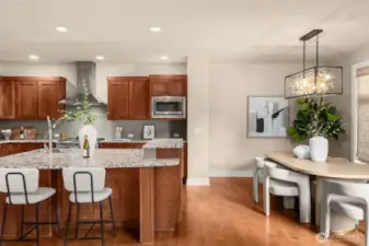 Kitchen leads into dining area with striking light feature