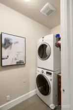 Laundry room conveniently located by primary suite