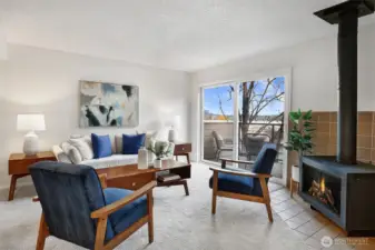 Living spaces are bright, inviting, and comfortable. A sweet mid-century inspired stove adds warmth and ambiance to the space.