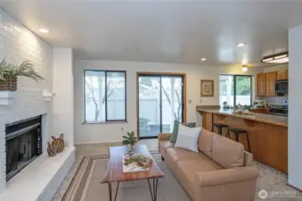 to the left of the front door, living room with fireplace, kitchen with counter seating.