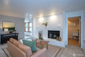 Beautiful brick fireplace, accent wall, and laudnry room with utility sink.