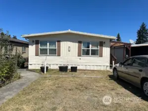 Front of home with 2 car parking