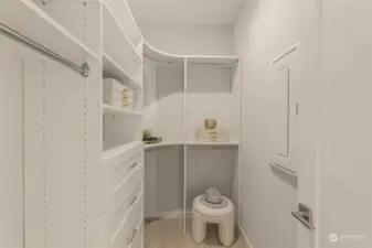 Organize your wardrobe with ease in this spacious walk-in closet. Custom shelving and ample storage make it simple to keep everything in its place.