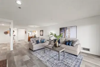 The open living room flows effortlessly from the dining area, creating a spacious and connected feel that's perfect for both relaxing and entertaining.