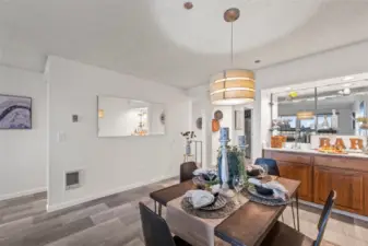 The open flow between the dining area and wet bar allows for seamless gatherings, whether it’s a cozy dinner party or a casual weekend brunch. The combination of vintage charm and modern updates makes this space both functional and effortlessly stylish.