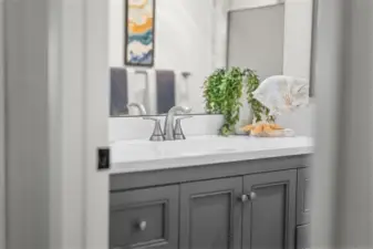 The secondary bathroom is equally refreshed with updated lighting, new vanity, and contemporary tile finishes — perfect for guests or everyday use.
