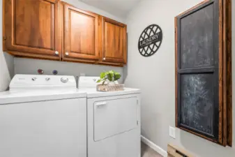 The dedicated laundry room includes a full-size washer and dryer, plus ample storage. Practical and convenient.