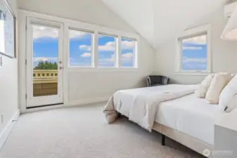 West facing primary suite with vaulted ceilings, wall of windows, and access to relaxing view balcony.