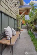 Covered main entry has rockery's that add greenery & privacy.