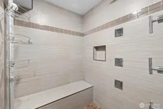 Lower shower is big with bench.