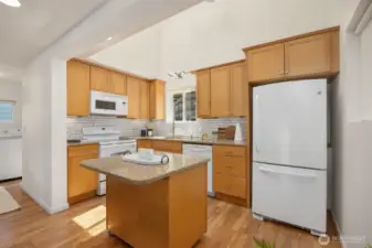 Very nice kitchen with granite counters and wood cabinets. The washer and dryer and full bathroom is to the left.