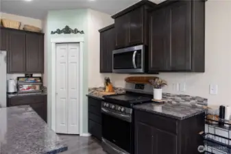 Gas cook top covered with a decorative board in the photos.