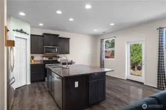 Well lit with multiple canned lights and natural lighting formt he sliding glass door and windows.