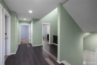 2nd floor landing with access to laundry room, Primary bedroom, 2 cozy bedrooms and a large bedroom and or bonus room.