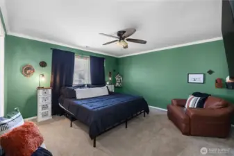 Primary bedroom with overhead fan.