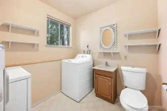 Utility room with a convenient half bath downstairs.