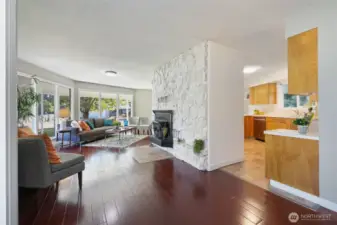 The living area with open concept with wood burning fireplace.