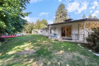 Many fruit trees, grape arbor, backyard completely fenced.