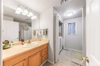 Tiled bathroom looks out to woods. New Samsung washer/dryer coming soon.