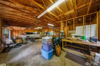 A practical shop for all your mechanical or gardening projects. Tool bench and plenty of overhead lighting.