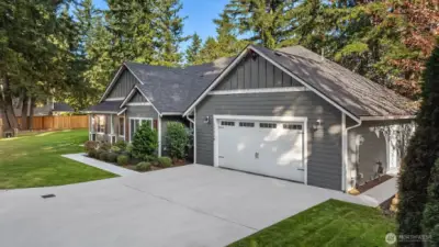 The extended driveway and spacious two-car garage provide ample parking and convenience.
