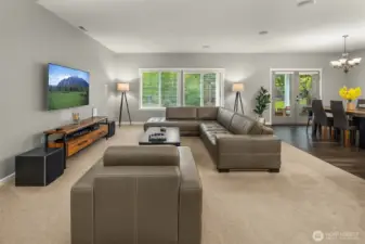 The living room blends warmth and sophistication with its soft natural light, clean design, and effortless flow to the dining and outdoor spaces.