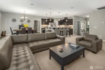 The open-concept design connects the living, dining, and kitchen spaces with effortless ease — inviting gatherings that flow seamlessly from conversation to cooking to quiet relaxation.