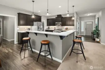 This chef-inspired kitchen pairs rich cabinetry with sleek quartz counters and pendant lighting — a stylish, functional space where cooking and conversation come together.