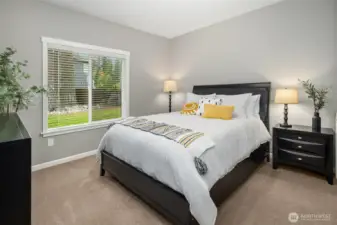 This comfortable bedroom offers peaceful views and a warm, restful ambiance — the perfect retreat for family or guests.