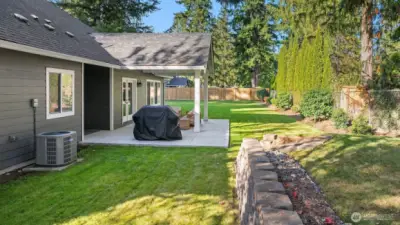 This expansive, flat backyard is ideal for barbecues, outdoor dining, and gatherings that flow effortlessly from the patio to the open lawn.