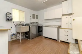 The utility room offers tons of storage along with a convenient sink, creating a practical space for laundry.