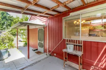 Step out onto a covered patio, ideal for outdoor meals and gatherings.