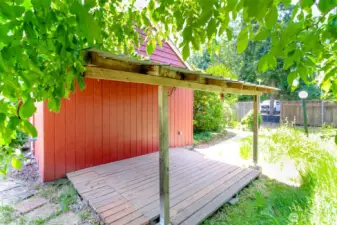 A charming covered deck offers the perfect spot for entertaining or relaxing outdoors.