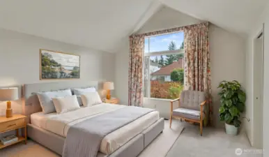 Primary bedroom features vaulted ceilings and a large walk-in closet