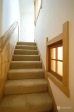 stairs to upstairs primary bedroom