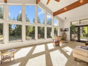 Family room has wall of windows and two sets of french doors to separate decks.