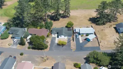 AREIAL VIEW OF THE HOME SHOWING THE PARKING AREA AND DRIVEWAYS TO THE GARAGES!  WELCOME HOME AGAIN!