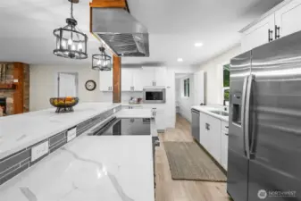 Chef's dream kitchen with abundant cabinetry, beautiful quartz counters, stainless steel appliances & huge island - great for gathering and entertaining!