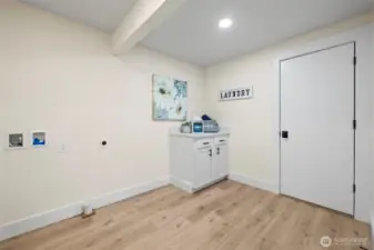 Spacious laundry room with door to garage.