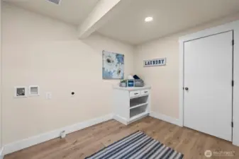 Spacious laundry room with door to garage.
