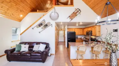 Open floor plan living area leads to the loft upstairs.