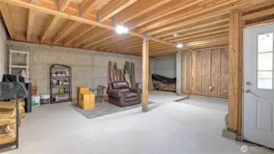 Below garage unfinished living area (565 sq ft) has roughed-in plumbing for a bath to serve as a potential living space.
