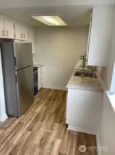 Unit 2 Kitchen, modern flooring, stainless steel appliances, and laminate countertops.