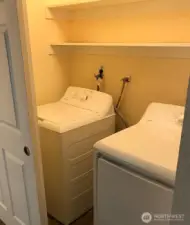 Laundry room has plenty of space for storage of cleaning supplies.