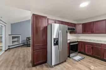 View from kitchen to living room - refrigerator does not stay with the home.
