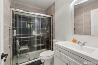 Primary bathroom has built-in grab bars for the shower, tile walls, and a recessed medicine cabinet. Updated exhaust fan lights with Bluetooth speakers for music, news, traffic, or podcasts, and a 1.5 sone exhaust fan.
