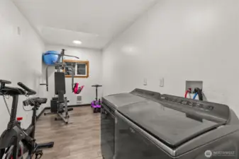 Oversized laundry room offering versatile space for additional activities and storage.