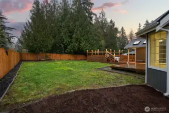 Rear yard with updated landscaping. Well-maintained and offers a great outdoor space.