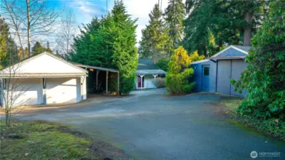 HUGE piece of land, 22,999 sf lot with small move in ready home. Two detached garages!