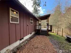 Second entrance on the opposite side of the home with lovely deck overlooking the land